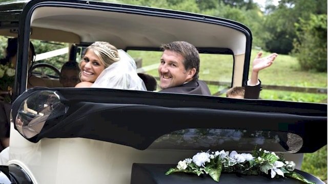The Bride and Groom being driven away in our Bramwith limousine