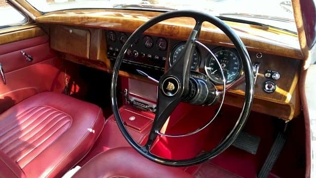 Interior view of our Jaguar Mk2 showing the front seats and walnut dashboard