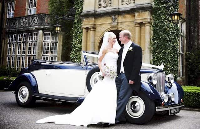 The Bride and Groom with our Jaguar drophead photographed ouside their reception