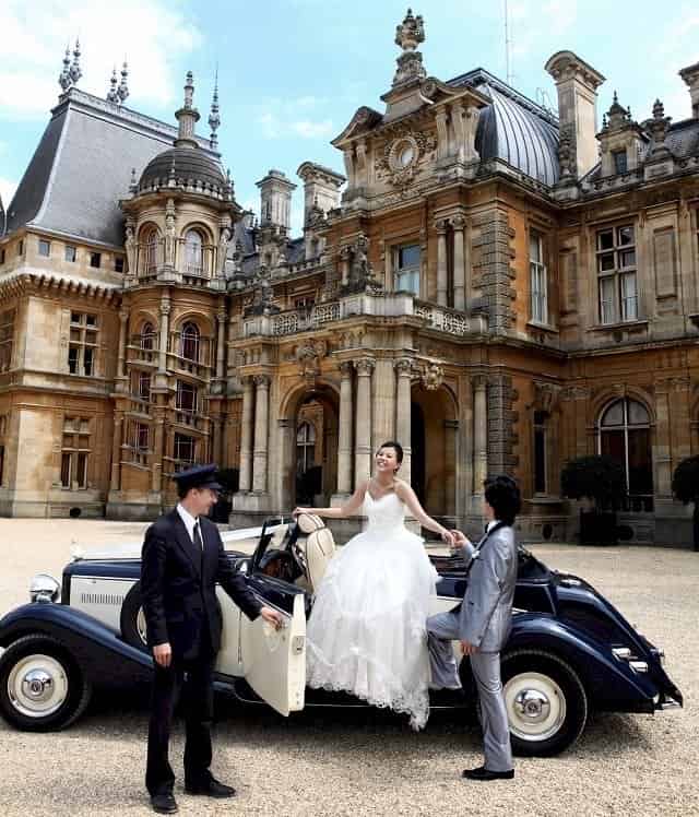 The Bride and Groom with their driver at Waddesdon Manor